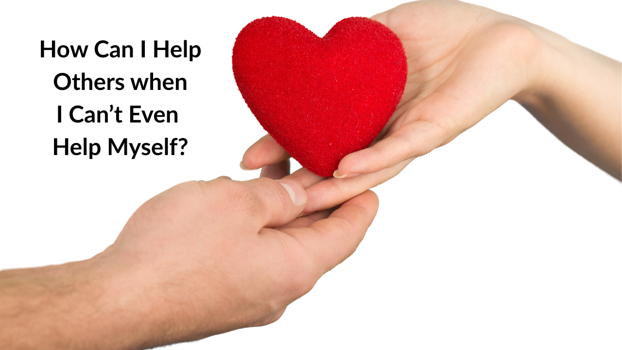 Two hands reaching for each other with a heart in between.